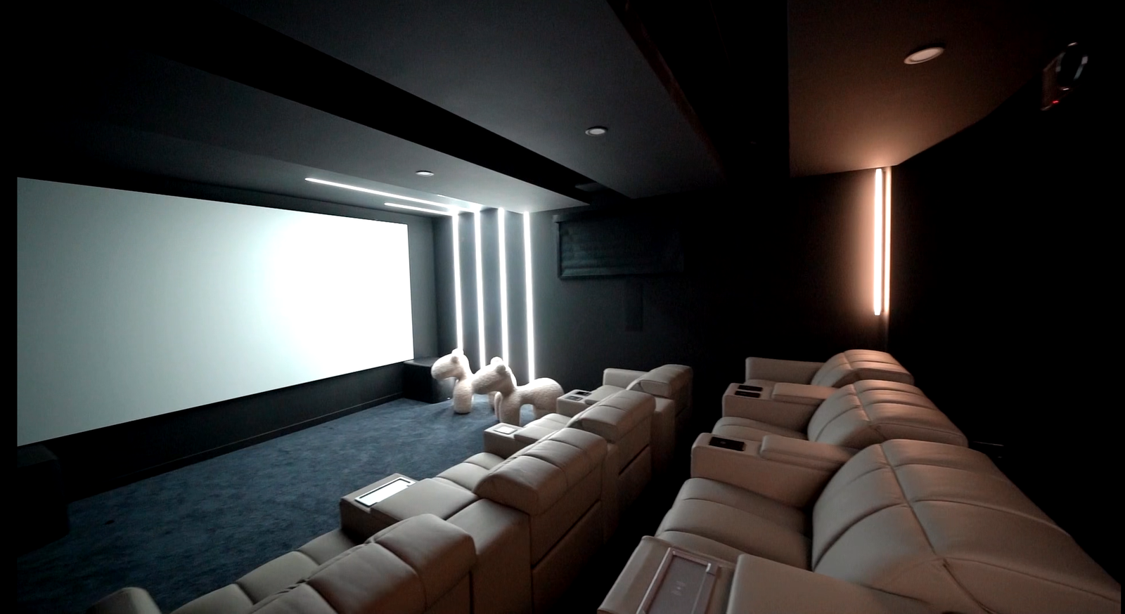 Dedicated home cinema room with tiered recliner seating